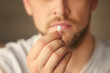 © Africa Studio - Hand of young man with pill, closeup