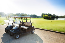 Two Golf-carts Standing At Parking Of Golf Club