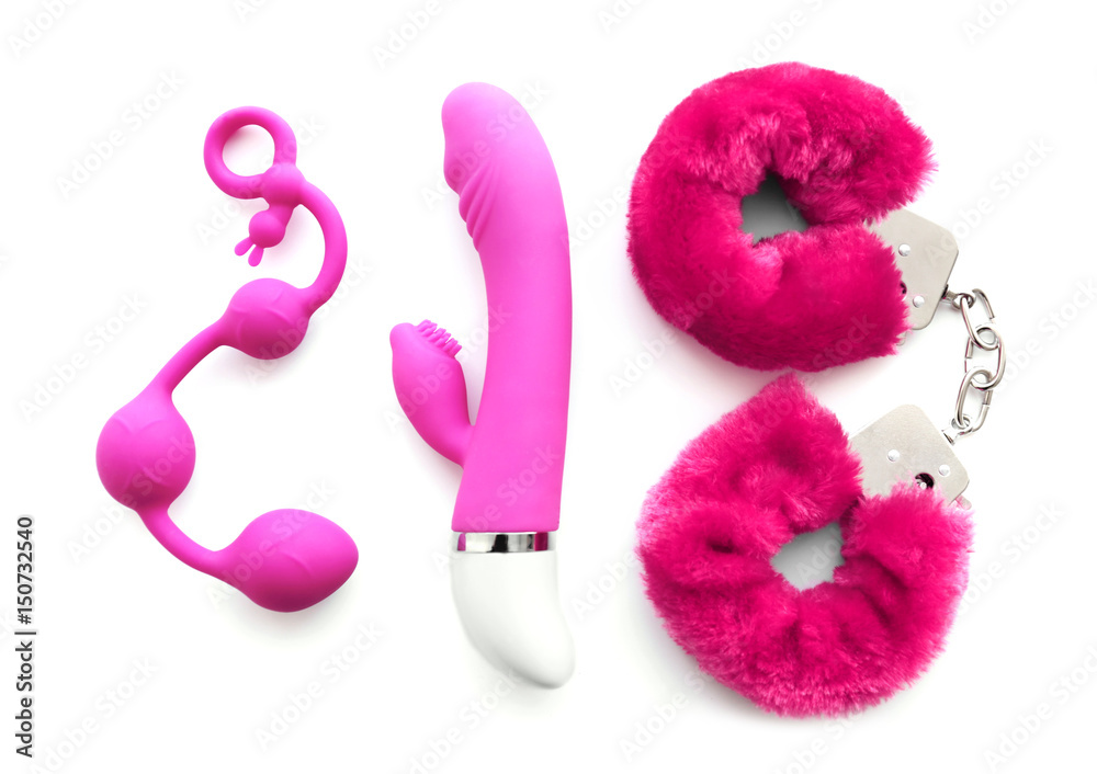 Vibrator, anal balls and handcuffs on white background