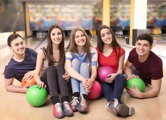 Wall Mural - Friends having fun in bowling club