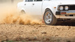 Retro Rally Car turning in dirt track
