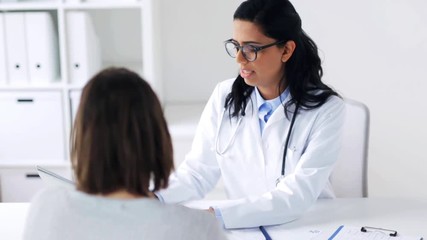 Wall Mural - doctor with clipboard and laptop and woman