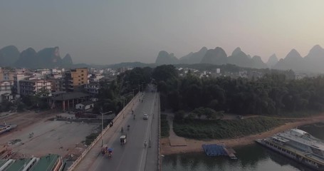 Wall Mural - Aerial view of sunrise over landscape of Yangshuo Town, Guanxi province, Guilin City, China. Li River and karst mountains top view. Travel, adventure and picturesque famous destination concept.