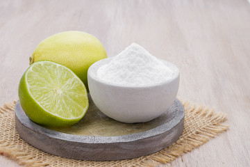 Wall Mural - Baking soda with lemon on wooden background