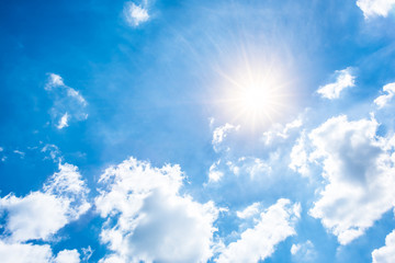 Wall Mural - Sunny background, blue sky with white clouds and sun