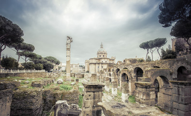 Roman ruins in Rome, Forum. Ancient ruins of the Romanum Forum. Ruins of Septimius Severus Arch and Saturn Temple, Rome, Italy.