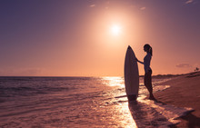 Female Surfer Girl On The Beach. 