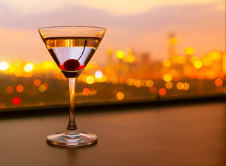 Wall Mural - Martini glass and a beautiful city view. 