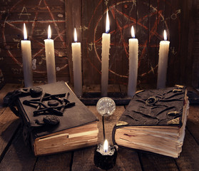 Poster - Esoteric still life with two black magic books and burning candles