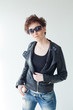 © dmitriisimakov - short hair girl in glasses and fancy leather jacket