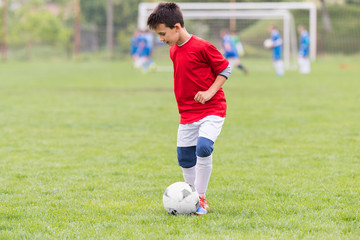 Wall Mural - Kids soccer football - children players match on soccer field