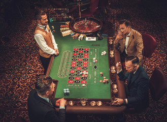 Wall Mural - Upper class friends gambling in a casino