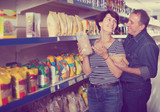 Fototapeta Na sufit - Husband and wife selecting a groats at the grocery store