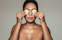 Beautiful Woman Holding Cucumber Over Eyes