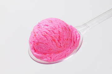 Wall Mural - Scoop of pink ice cream on spoon