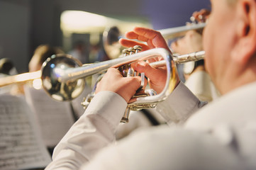 Trumpet in the hands of a musician in the band