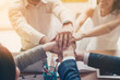 © deagreez - Close up photo of hands on top of each other of successful business partners who are working in team for one goal and happy to share victory with each other