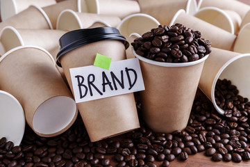 Wall Mural - coffee identity brand building concept with coffee beans and lots of paper coffee cups background