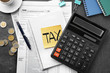 © Africa Studio - Paper sheet with text TAX, notepad, calculator and individual income tax return form on table