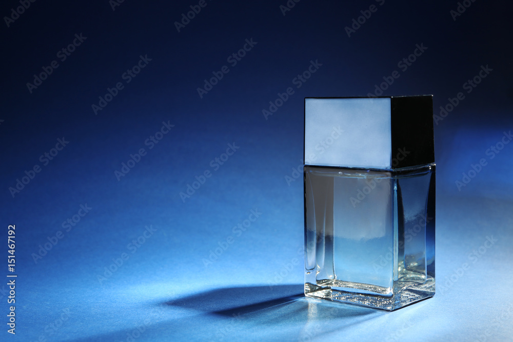Bottle of modern male perfume on color background