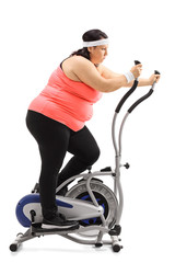 Poster - Tired overweight woman exercising on a cross trainer machine