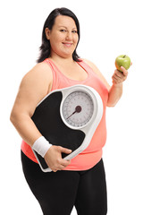 Poster - Overweight woman holding a weight scale and an apple