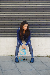 Wall Mural - Fitness woman resting after jumping rope. Urban outdoor healthy workout.