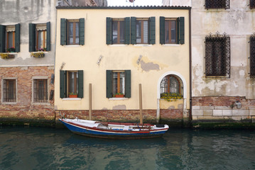 Boat parking in front of old facade building