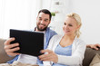© Syda Productions - smiling happy couple with tablet pc at home
