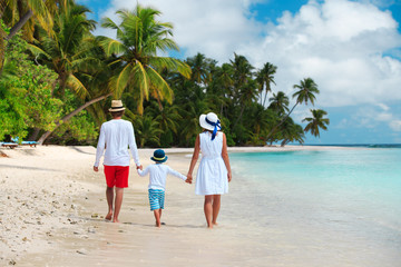 happy family with child walking on beach