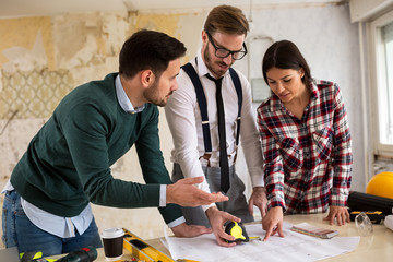 Wall Mural - Three  architects checking blueprint