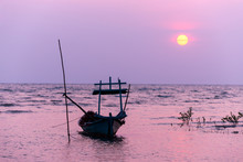 Small Fishing Boat At Sunset In The Sea
