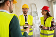 © didesign - Group of architects talking on coffee break at construction site