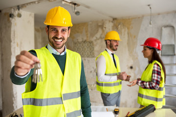 Wall Mural - Young worker holding the key, buying a home