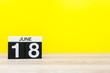 © bychykhin - June 18th. Day 18 of month, calendar on yellow background. Summer day. Empty space for text