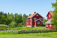 Red Farm House In Rural Environment