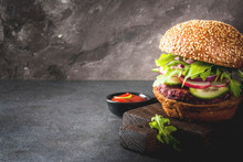 Healthy Vegan Burgers With Beets, Carrots, Spinach, Arugula, Cucumber, Radish And Tomato Sauce, Whole Grain Buns On A Rustic Wooden Board On A Dark Stone Background, Selective Focus, Copy Space