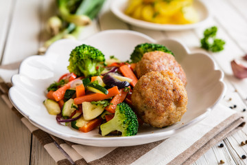 Wall Mural - Fried pork burgers served with steamed vegetable