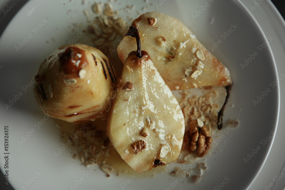 Tasty pears with honey sauce and oat flakes, closeup