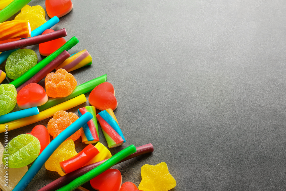 Tasty jelly candies on grey background