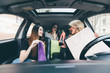 © F8  \ Suport Ukraine - Three women have fun and happy about shopping and new shoes in the car