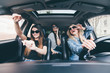 © F8  \ Suport Ukraine - three girls driving in a convertible car and having fun, listen music and dance