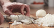 © GCapture - man cutting white onion with knife, 4k photo