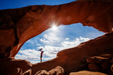 Fototapeta  - Mother with her baby son stay below Skyline arch in Arches National Park in Utah, USA