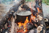 Fototapeta Morze - Boiling water in the bowler on the bonfire