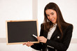 © Samo Trebizan - Beautiful young  business woman holding blank blackboard isolated over white background