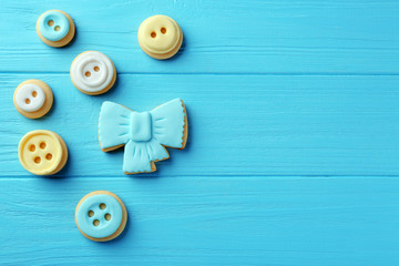 Wall Mural - Baby cookies decorated with glaze on wooden background