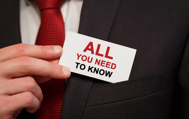 Aufkleber - Businessman putting a card with text All you need to know in the pocket