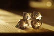 © Alicja - Few transparent rpg dice on table highlighted by the sun. D&D - Dungeons and dragons.