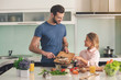 © Friends Stock - Young father and daughter cooking meal together